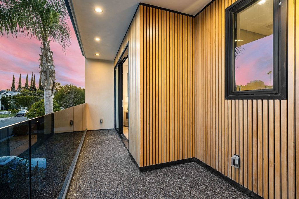 Modern balcony with vertical composite exterior wall panels adding a stylish design element to the home.