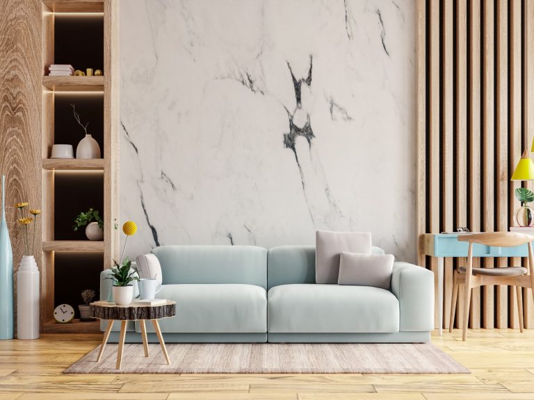A modern living room featuring an accent wall with white PVC marble sheets.